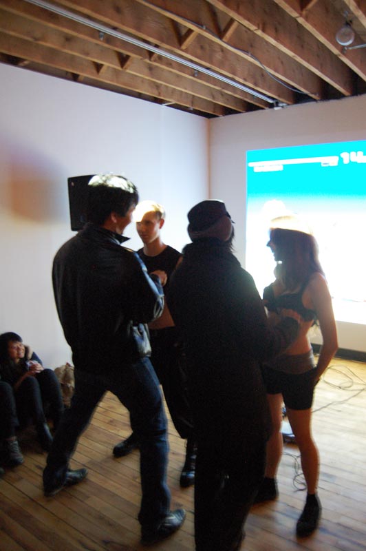 Audience members playing on Daniele and Kyle's PS1 controller bra/bro